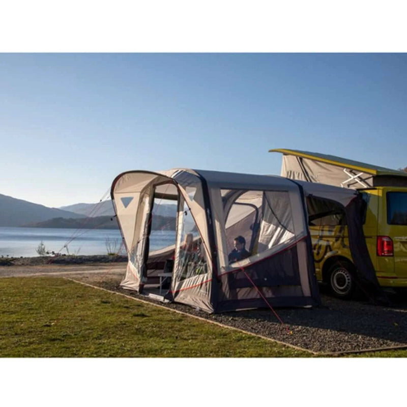 Vango Tolga VW Inflatable Drive Away Awning set up beside a campervan by a scenic lake view.