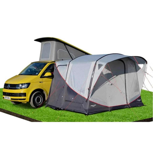 Vango Tolga VW Inflatable Drive Away Awning connected to a yellow campervan on grass.