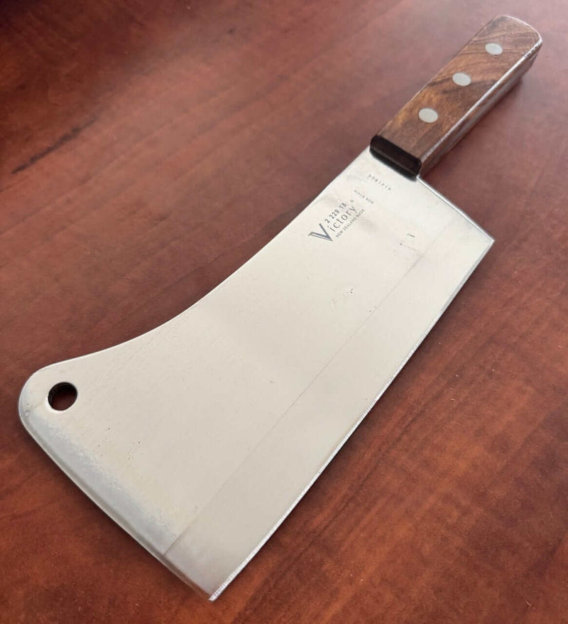 Victory Kitchen Cleaver 2-229-18-120WD on wooden surface, showcasing its stainless steel blade and hardwood handle.