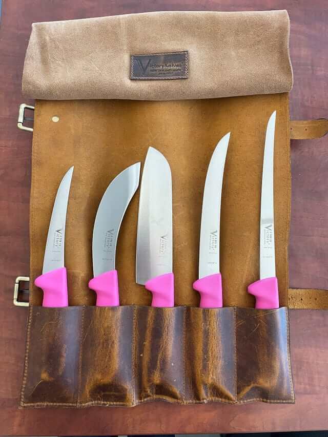 Victory Pink Knife Set displayed in a roll-up case, featuring pink Progrip handles and various knife types.