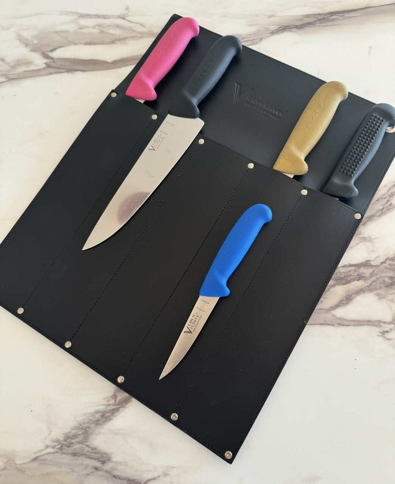 Victory Knife Safe displaying a variety of colored kitchen knives in a leather storage case.
