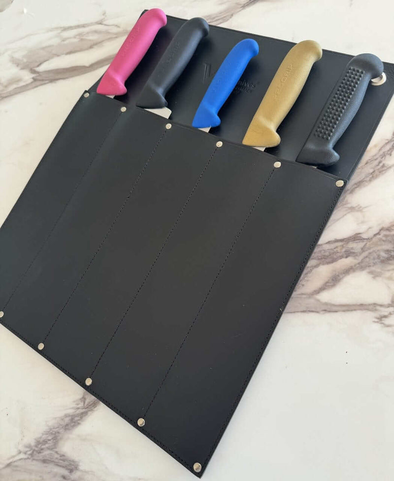 Victory Knife Safe displaying securely stored knives in a durable leather holder on a marble surface.