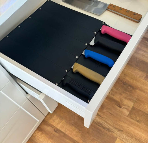 Victory Knife Safe securely storing knives in a drawer with colorful handles visible.